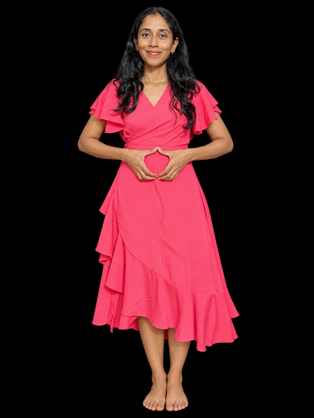 Birundha, your postpartum fitness coach, wearing a pink dress